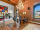 Dining area with rustic exposed brick wall, hardwood floors, and modern chandelier at 1792 Wynkoop St # 508, Denver, CO 80202