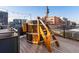 A wooden hot tub with a ladder, surrounded by a rooftop deck with views of the city at 1792 Wynkoop St # 508, Denver, CO 80202