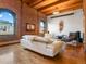 Cozy living room with exposed brick wall, hardwood floors, and ample natural light at 1792 Wynkoop St # 508, Denver, CO 80202