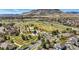 An aerial view captures a park with playground, walking trails, and scenic views of the surrounding neighborhood at 6273 Torrey Ln, Arvada, CO 80403