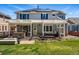 Beautiful backyard with pergola, outdoor kitchen, hot tub, and well-manicured lawn at 6273 Torrey Ln, Arvada, CO 80403