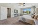 Light and airy bedroom featuring a large window with backyard views and cozy decor at 6273 Torrey Ln, Arvada, CO 80403