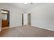 Neutral bedroom with carpet, ceiling fan and adjacent bathroom and closet at 6273 Torrey Ln, Arvada, CO 80403