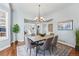 Elegant dining room with a chandelier, hardwood floors, and view to an open-concept living area at 6273 Torrey Ln, Arvada, CO 80403