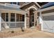 Charming exterior view of a home with stone accents, a front porch, and well-maintained landscaping at 6273 Torrey Ln, Arvada, CO 80403