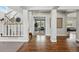Inviting foyer with hardwood floors, staircase and an open view to a bright office space at 6273 Torrey Ln, Arvada, CO 80403