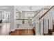 Welcoming home foyer with hardwood floors, white staircase, and great natural light at 6273 Torrey Ln, Arvada, CO 80403