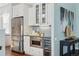 Modern kitchen featuring stainless steel appliances, white cabinets, and stylish backsplash at 6273 Torrey Ln, Arvada, CO 80403