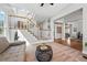 Sunlit living room featuring a staircase, hardwood floors, and an open floor plan at 6273 Torrey Ln, Arvada, CO 80403