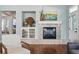 Cozy living room showcasing a fireplace, built-in shelving, and comfortable seating arrangement at 6273 Torrey Ln, Arvada, CO 80403