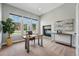 Home office featuring natural light, a modern desk, a stone fireplace, and tasteful decor at 6273 Torrey Ln, Arvada, CO 80403