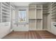 Organized walk-in closet with custom shelving, drawers, and ample storage space at 6273 Torrey Ln, Arvada, CO 80403