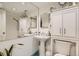 Bright bathroom featuring pedestal sink, white cabinetry, large mirror, and tiled floors at 790 N Washington St # 1003, Denver, CO 80203