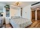 Cozy bedroom with a fold-down Murphy bed, built-in shelving, stylish fan, and hardwood floors at 790 N Washington St # 1003, Denver, CO 80203