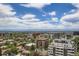 Expansive city view featuring mature trees and a blue sky with white fluffy clouds at 790 N Washington St # 1003, Denver, CO 80203