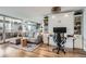Comfortable living area featuring a gray sectional sofa, hardwood floors, and a built-in Murphy bed with shelving and desk at 790 N Washington St # 1003, Denver, CO 80203