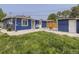 The backyard features a lawn and a blue painted home at 3610 Olive St, Denver, CO 80207