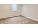 The basement bedroom features wood floors, a window and a double door closet at 3610 Olive St, Denver, CO 80207