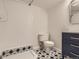 This bathroom has a shower and a toilet with black and white tiling at 3610 Olive St, Denver, CO 80207