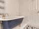 The bathroom features a claw foot tub, decorative tiling, and gold accents at 3610 Olive St, Denver, CO 80207