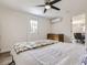 This bright bedroom features a ceiling fan, wood floors, white walls and access to the exterior at 3610 Olive St, Denver, CO 80207