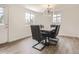 Well-lit dining room with contemporary lighting, seating for six, and hardwood floors at 3610 Olive St, Denver, CO 80207