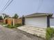 A two car detached garage with a large door at 3610 Olive St, Denver, CO 80207