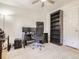 The home office has a ceiling fan, wood floors, large desk area, and a full sized book shelf at 3610 Olive St, Denver, CO 80207