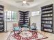 This room features a ceiling fan, wood floors, book shelves, comfortable seating and lots of natural light at 3610 Olive St, Denver, CO 80207