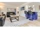 Spacious living room with hardwood floors, modern furniture, and an open layout with dining space at 3610 Olive St, Denver, CO 80207