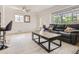 Bright, spacious living room features hardwood floors, neutral walls and a cozy seating area at 3610 Olive St, Denver, CO 80207