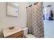 Bathroom featuring a modern sink, toilet, and a shower with decorative shower curtain at 828 S Osceola St, Denver, CO 80219