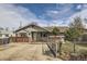 A charming one-story home with a fenced yard, inviting curb appeal, and driveway at 828 S Osceola St, Denver, CO 80219