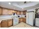 Bright kitchen featuring wood cabinets, modern appliances, and ample counter space at 828 S Osceola St, Denver, CO 80219