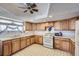 Kitchen featuring wood cabinets, modern appliances, ample counter space and vintage flooring at 828 S Osceola St, Denver, CO 80219