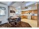 Bright eat-in kitchen with wood cabinets, modern appliances, and a cozy dining area at 828 S Osceola St, Denver, CO 80219
