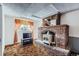 Bright living room featuring a brick fireplace, vintage stove and comfortable seating at 828 S Osceola St, Denver, CO 80219