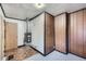 A spacious utility room with wood paneled walls, and tile and carpet flooring at 828 S Osceola St, Denver, CO 80219
