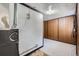 A utility room featuring a furnace, wood paneled walls, carpet and tile flooring at 828 S Osceola St, Denver, CO 80219