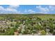 Expansive aerial view showcasing a charming residential area with green trees and rolling hills on a sunny day at 1522 Utah St, Golden, CO 80401