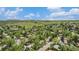 Scenic aerial view of a residential neighborhood with lush greenery and mountain backdrop under a blue sky at 1522 Utah St, Golden, CO 80401