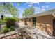 Spacious backyard featuring a brick home exterior with an outdoor patio and garden area at 1522 Utah St, Golden, CO 80401