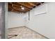 Unfinished basement area, ready for customization, with exposed beams and windows for natural light at 1522 Utah St, Golden, CO 80401