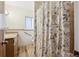 Bathroom featuring floral shower curtain, updated vanity, and tiled walls at 1522 Utah St, Golden, CO 80401