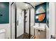 Modern bathroom featuring a glass-enclosed shower, dark green accent wall, and stylish vanity at 1522 Utah St, Golden, CO 80401