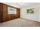 Carpeted bedroom featuring wood paneled accent wall and bright windows at 1522 Utah St, Golden, CO 80401
