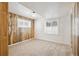 Bedroom with rustic wood accent wall, carpet, and two windows, providing a blend of textures and natural light at 1522 Utah St, Golden, CO 80401