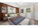 Cozy bedroom with wood paneled walls, a comfortable bed, and decorative windows at 1522 Utah St, Golden, CO 80401