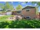 Charming brick home with lush green lawn and rock garden in front at 1522 Utah St, Golden, CO 80401