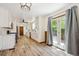 Bright open kitchen with stainless appliances, white cabinets, and door to the back yard at 1522 Utah St, Golden, CO 80401